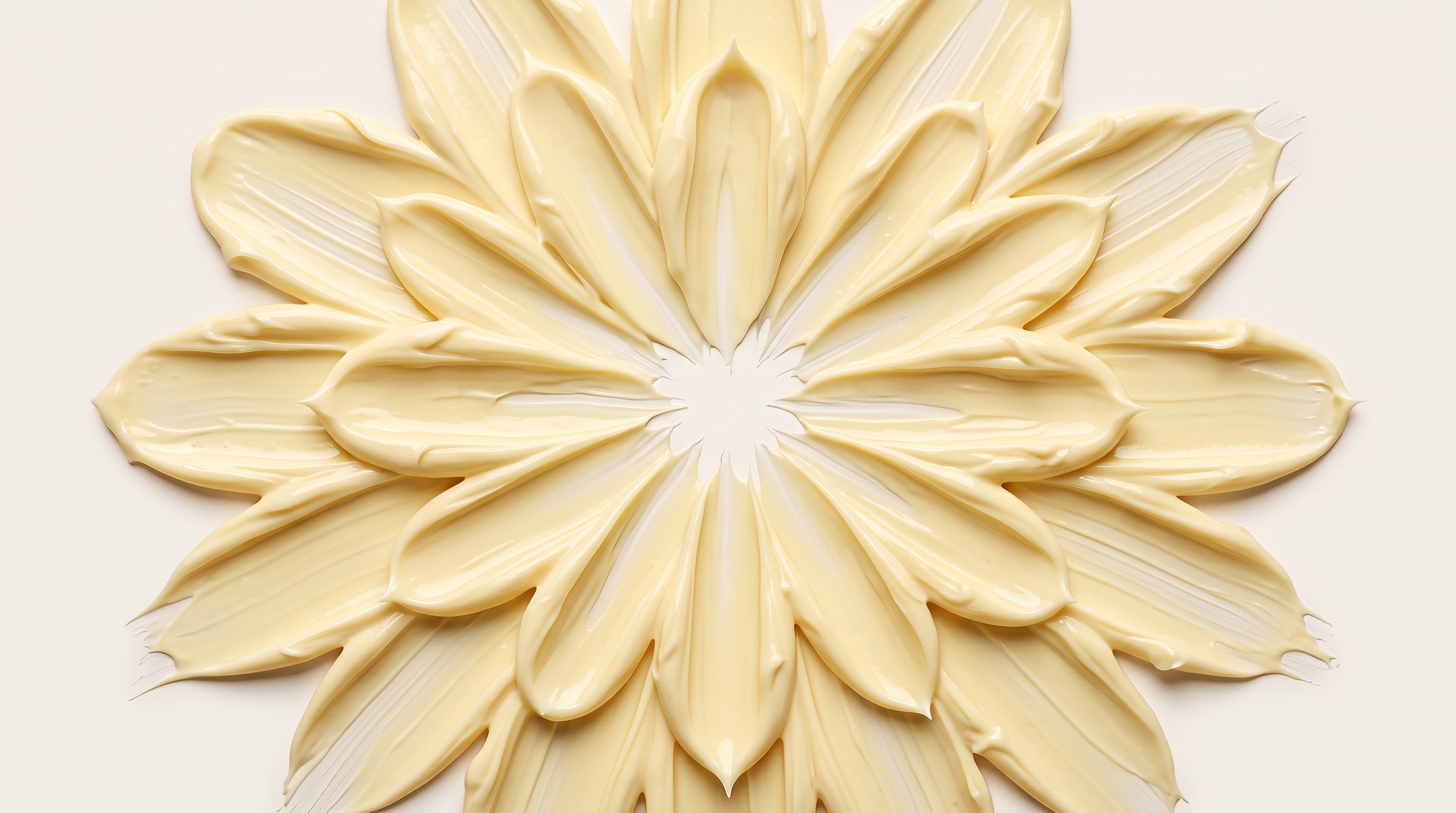 Pale yellow cream smeared on a beige surface